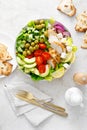 Greek inspired salad with grilled chicken meat, vegetables and feta cheese in a bowl on a table, with olive oil dressing Royalty Free Stock Photo