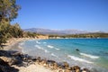 Greek island coast with clear blue sea, trees above the water by sandy beach on a summer day, south of Crete Royalty Free Stock Photo