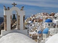 Greek Islands style white bell-tower and blue domes of the church at Oia village, Santorini island Royalty Free Stock Photo