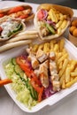 Greek kalamaki and pita gyros with grilled meat served for take away in a fast food restaurant Royalty Free Stock Photo