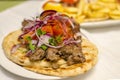 Greek kebab on pita with onions, tomatoes. Traditional Greek Cuisine