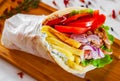 Meat gyros with tzatziki sauce, vegetables, feta cheese and french fries