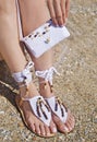 Greek leather sandals and white cotton bag advertisement on the beach Royalty Free Stock Photo