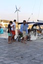 Greek man with baby goats on the waterfront