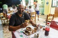 Greek man eating traditional local fast food gyros in a street taverna on Rhodes Island, Dodecanese, Greece