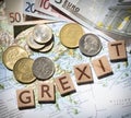 Greek map, euros and drachma grexit letters from above