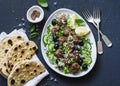 Greek meatballs with avocado greek yogurt sauce, couscous and whole grain flatbread on a dark background, top view. Mediterranean Royalty Free Stock Photo