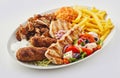 Greek mixed grill platter with salad and chips Royalty Free Stock Photo