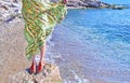 Greek model advertises bohemian sandals and clothes at the beach