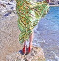 Greek model advertises bohemian sandals and clothes at the beach