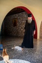 Greek Monk playing with his Cats