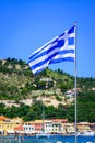 The Greek National Flag over seascape, beautiful turquoise sea , summer travel vacation. Royalty Free Stock Photo