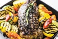 Greek organic lamb steak with vegetables and herbs in skillet