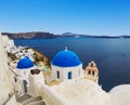 The Greek Orthodox Church on the background waters of the Aegean sea in Oia town on Santorini island Royalty Free Stock Photo