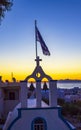 Greek Orthodox church tower with Greek flag waving Kamari Santorini Royalty Free Stock Photo