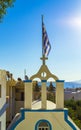 Greek Orthodox church tower with Greek flag waving Kamari Santorini Royalty Free Stock Photo