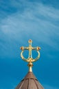 Greek orthodox golden decorated cross in blue sky
