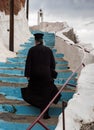 Greek-Orthodox priest on stairs Royalty Free Stock Photo