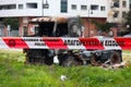 Greek police tape in front of a burnt truck