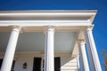 greek revival pillar details against a blue sky
