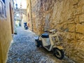 Greek Rhodes old town motorbike scooter alleyway.