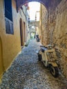 Greek Rhodes old town motorbike scooter cycle alleyway cobbled street. Royalty Free Stock Photo