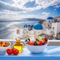 Greek salad against famous church in Oia village, Santorini island in Greece Royalty Free Stock Photo