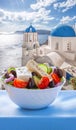 Greek salad against famous church in Oia village on Santorini island in Greece Royalty Free Stock Photo