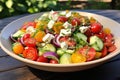 Greek salad, artistically arranged in a bowl atop a rustic wooden tabletop. Ai generated Royalty Free Stock Photo