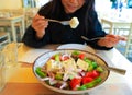 Greek salad bowl with fresh vegetables and feta cheese-which woman eating Healthy diet food concept Royalty Free Stock Photo