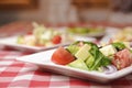 Greek salad with cheese, juicy tomatoes, red pepper, red onion, cucumber and lettuce Royalty Free Stock Photo