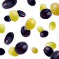 Black and green olives flying over white background Royalty Free Stock Photo