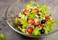 Greek salad with cucumber, tomato, pepper, lettuce, onion, feta cheese and olives, dressed with olive oil. Macro. Royalty Free Stock Photo