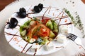 Greek salad in the deep white plate with a fork and knife Royalty Free Stock Photo