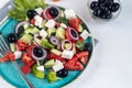 Greek salad. Diced tomatoes, cucumbers, feta cheese, olives.