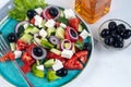 Greek salad. Diced tomatoes, cucumbers, feta cheese, olives.