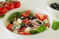 Greek salad with feta cheese, olives, juicy tomatoes, red pepper, red onion, cucumber and lettuce. Concept for healthy nutrition. Royalty Free Stock Photo