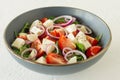 Greek salad with feta cheese, olives, juicy tomatoes, red pepper, red onion, cucumber and lettuce. Concept for healthy nutrition. Royalty Free Stock Photo