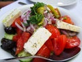 Greek salad with feta cheese, organic kalamata olives, juicy tomatoes, red pepper, red onion, cucumber and lettuce. Concept for Royalty Free Stock Photo