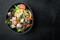 Greek salad with feta cheese and organic olives, on black background, top view flat lay  with copy space for text Royalty Free Stock Photo