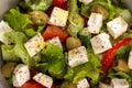 Greek salad with feta cheese, organic olives, juicy tomatoes, red pepper, red onion, cucumber and lettuce Royalty Free Stock Photo