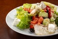 Greek salad with feta cheese, organic olives, juicy tomatoes, red pepper, red onion, cucumber and lettuce Royalty Free Stock Photo