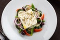 Greek salad with feta cheese, organic olives, juicy tomatoes, red pepper, red onion, cucumber and lettuce Royalty Free Stock Photo