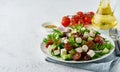 Greek Salad with feta and tomatoes, dieting food on white background copy space closeup