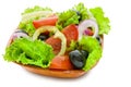 Greek salad of fresh bright vegetables, green lettuce, tomato and onion isolated on white background