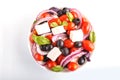 Greek salad with fresh cherry tomatoes, feta cheese, black olives, basil and onion isolated on white Royalty Free Stock Photo