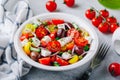Greek salad with fresh cucumber, tomato, lettuce, capers, red onion, feta cheese and olives Royalty Free Stock Photo