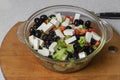 Greek salad of fresh cucumber, tomato, sweet pepper, lettuce, feta cheese and olives with olive oil Royalty Free Stock Photo