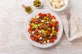 Greek salad of fresh cucumber, tomato, sweet pepper, lettuce, red onion, feta cheese Royalty Free Stock Photo