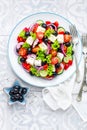 Greek salad of fresh cucumber, tomato, sweet pepper, lettuce, red onion, feta cheese and olives with olive oil Royalty Free Stock Photo